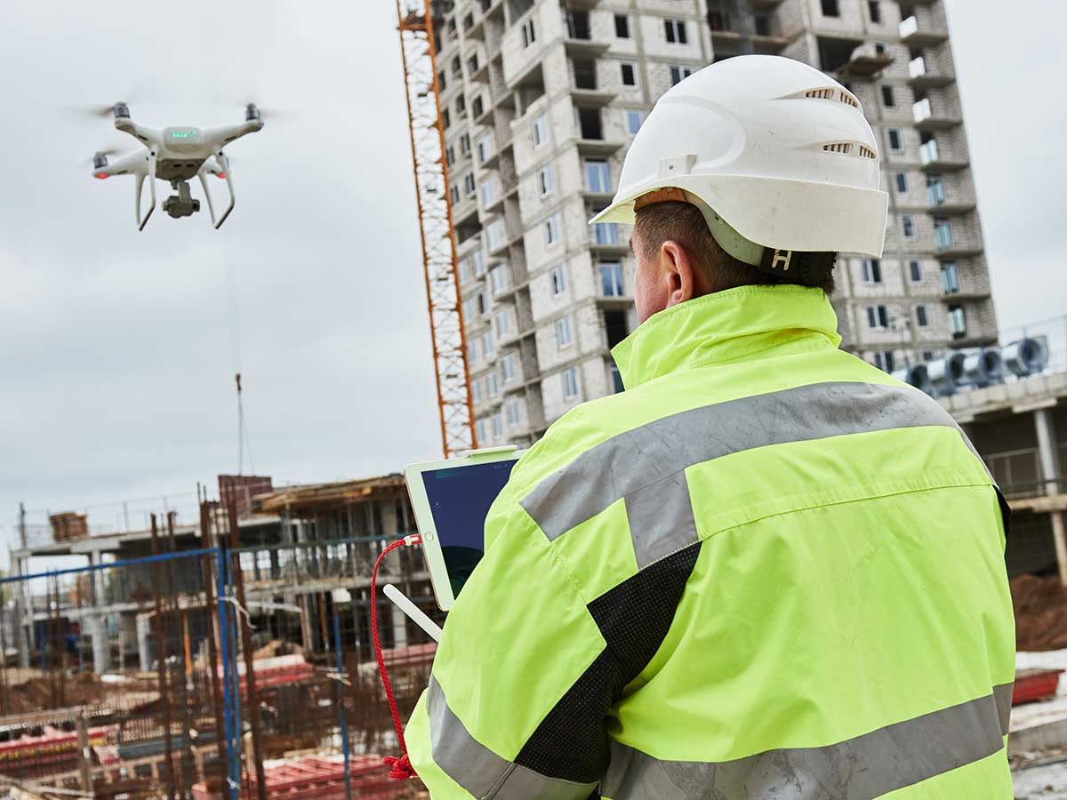 Drone operated by construction worker on building site