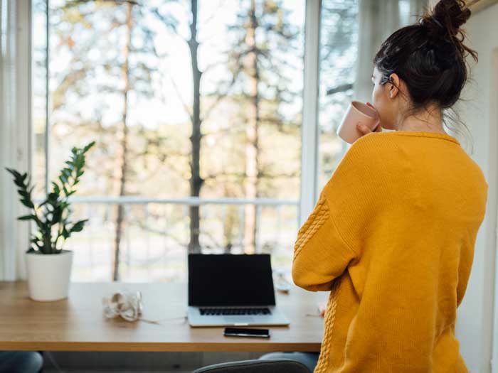 Young woman taking a break in her home office while working from home during the COVID-19 pandemic