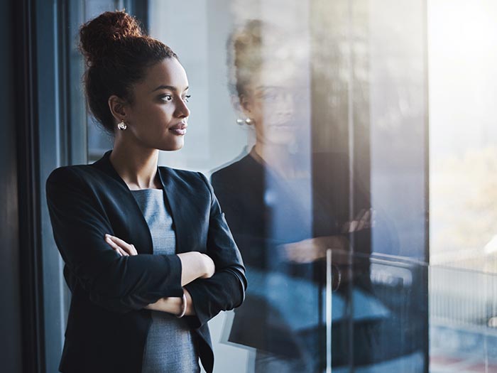 Young professional looking out of window