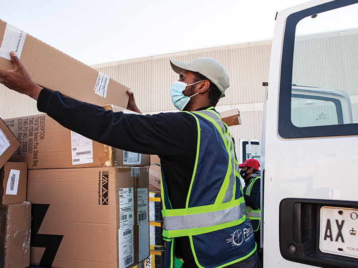 FleetOptics worker loading boxes