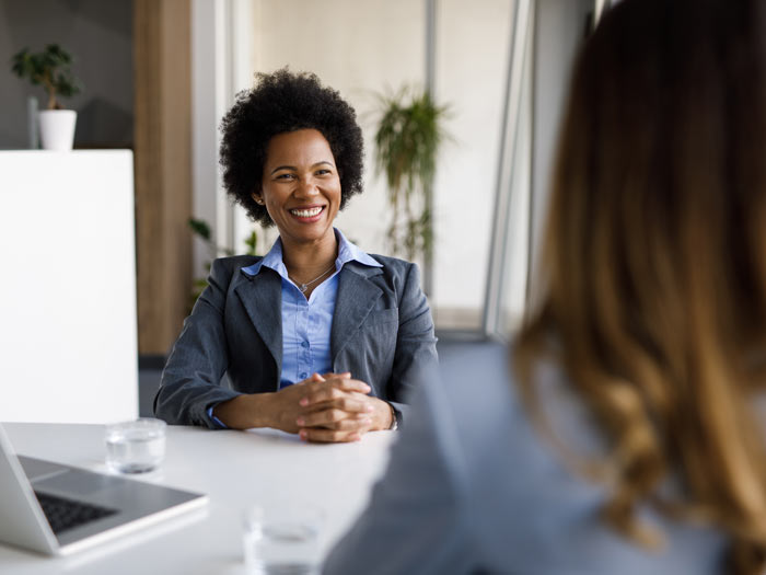 Two diverse businesswomen talking, working together in office 